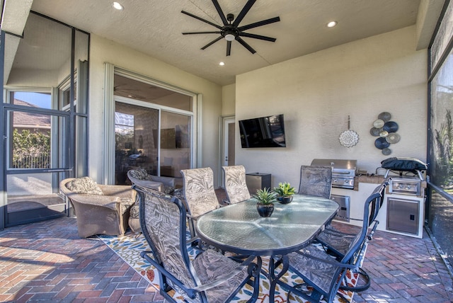 view of patio with a grill and ceiling fan