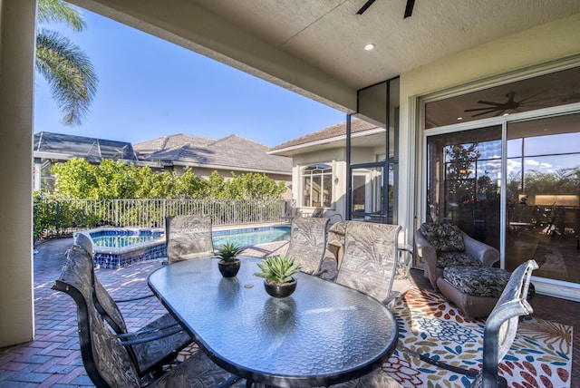 7541 Monte Verde Ln, West Palm Beach, FL 33412 - view of patio / terrace featuring ceiling fan, an in-ground hot tub, outdoor dining space, and a fenced backyard