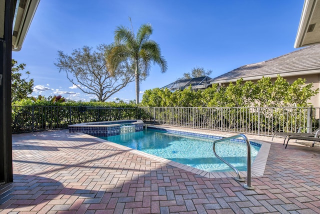 view of pool with an in ground hot tub and a patio