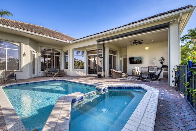 view of pool with ceiling fan and a patio