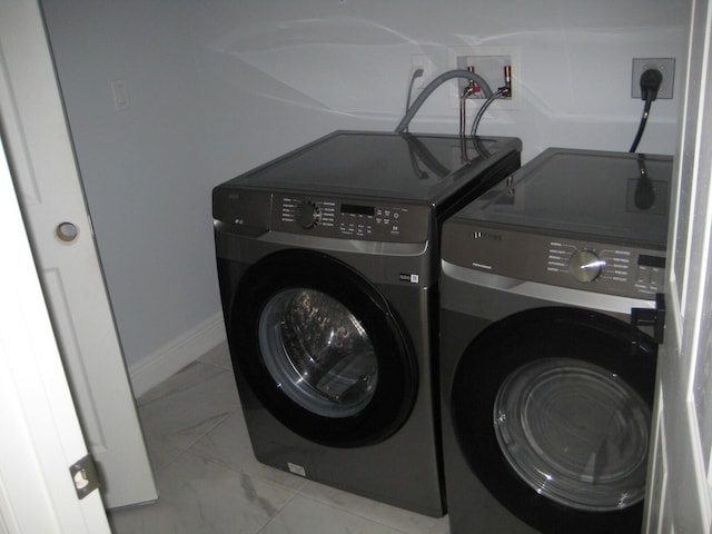 laundry room with washing machine and clothes dryer