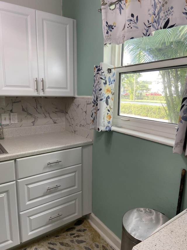 kitchen with white cabinets and backsplash