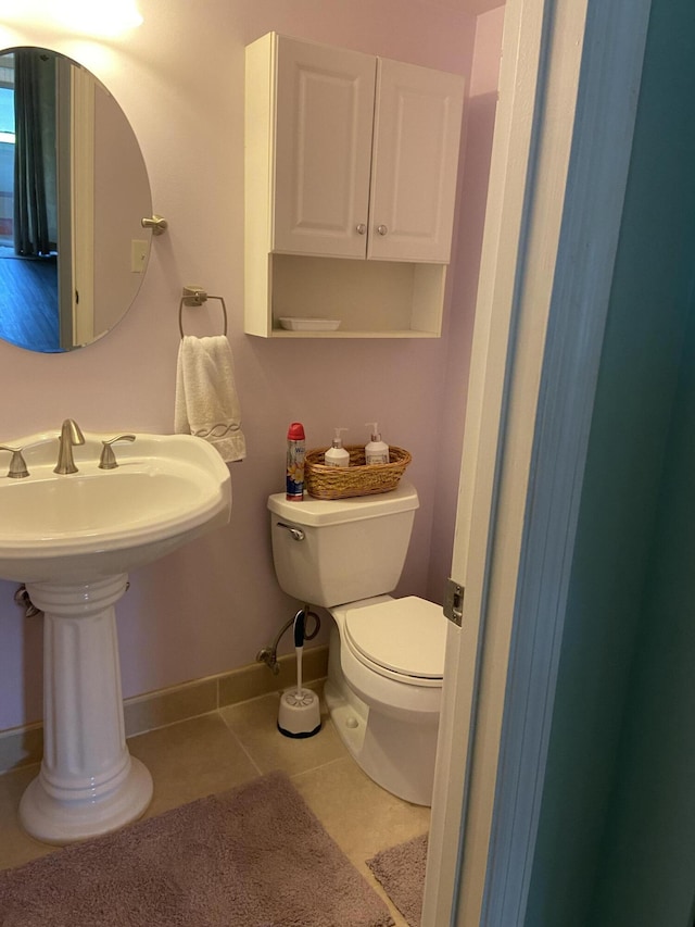 bathroom with tile patterned flooring and toilet