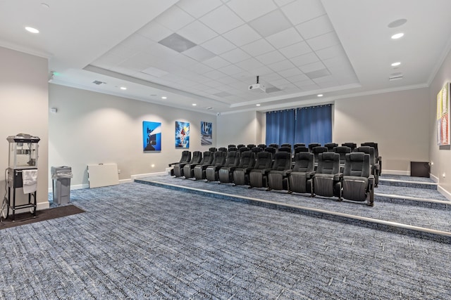 carpeted home theater featuring a tray ceiling and crown molding