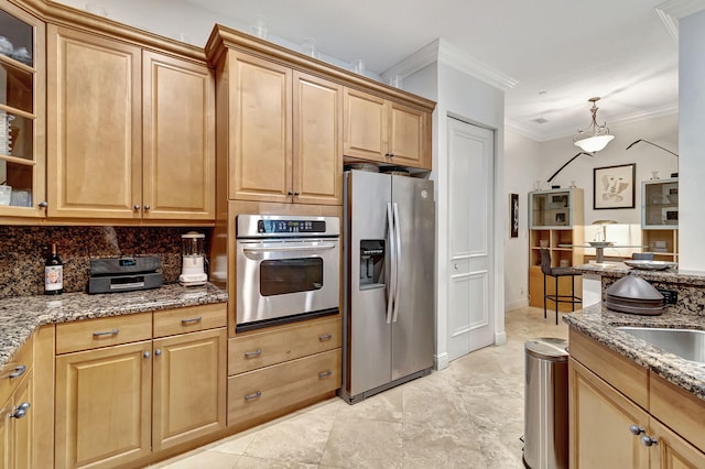 kitchen with ornamental molding, stainless steel appliances, dark stone counters, and tasteful backsplash