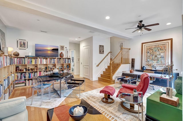 living room featuring ceiling fan and light hardwood / wood-style flooring