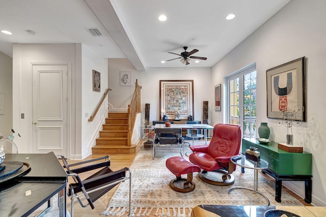 living area featuring ceiling fan and light hardwood / wood-style flooring