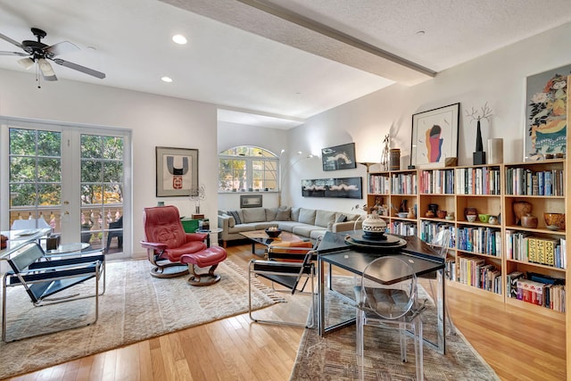 interior space featuring a wealth of natural light, ceiling fan, a textured ceiling, and hardwood / wood-style flooring