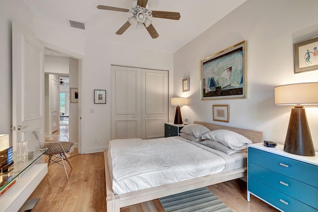 bedroom featuring light hardwood / wood-style floors, a closet, and ceiling fan