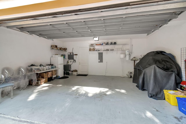 garage featuring white refrigerator and electric panel