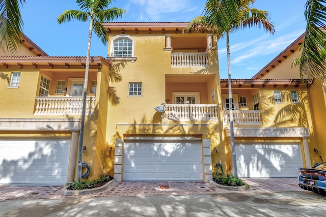 mediterranean / spanish-style home featuring a balcony and a garage