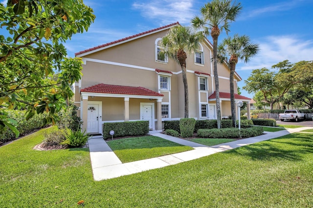 mediterranean / spanish-style home with a front yard