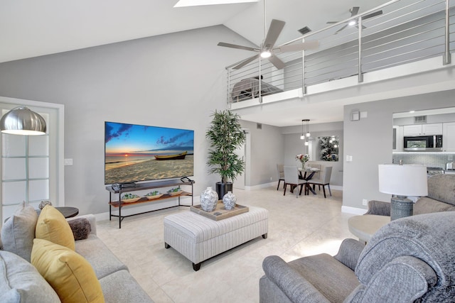 living room with ceiling fan and high vaulted ceiling