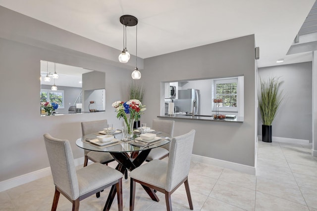 tiled dining area with a wealth of natural light