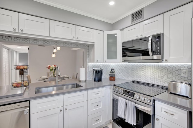 kitchen with white cabinets, backsplash, stainless steel appliances, and sink