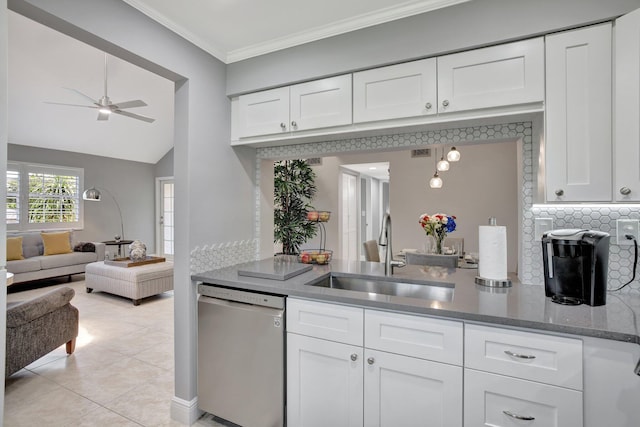 kitchen featuring dishwasher, sink, ceiling fan, light tile patterned floors, and white cabinetry