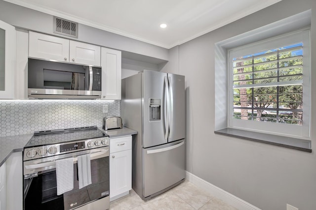 kitchen featuring backsplash, stainless steel appliances, crown molding, light tile patterned floors, and white cabinets