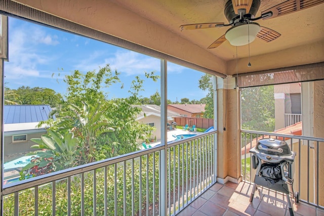 unfurnished sunroom with ceiling fan