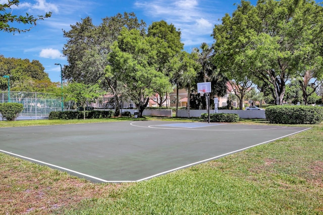 view of sport court with a lawn