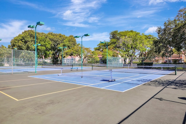 view of tennis court featuring basketball hoop