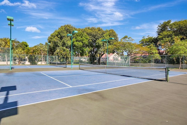 view of tennis court featuring basketball hoop