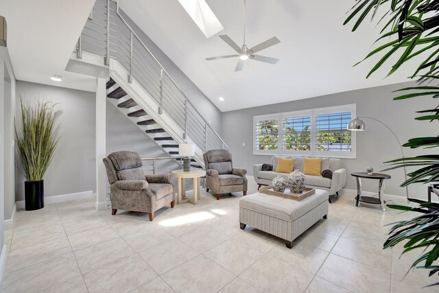 tiled living room with high vaulted ceiling and ceiling fan