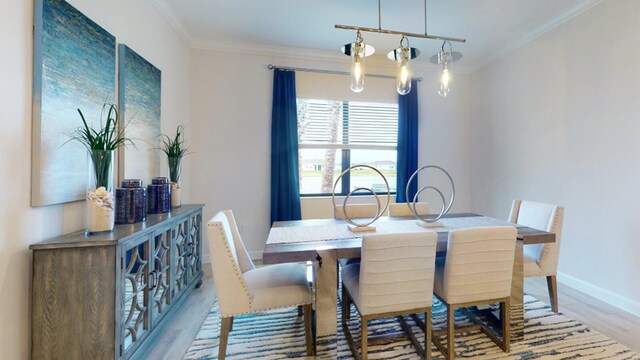 dining area with light hardwood / wood-style floors and ornamental molding