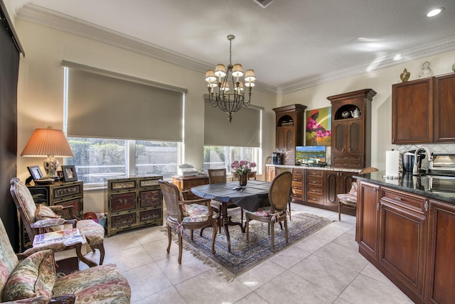 tiled dining room featuring a chandelier and crown molding