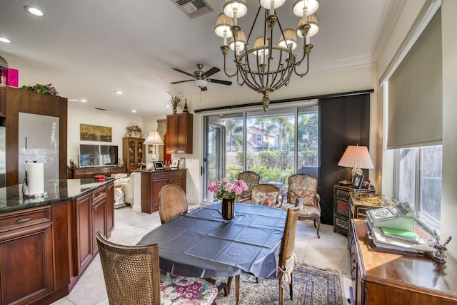 tiled dining area featuring ceiling fan with notable chandelier and ornamental molding