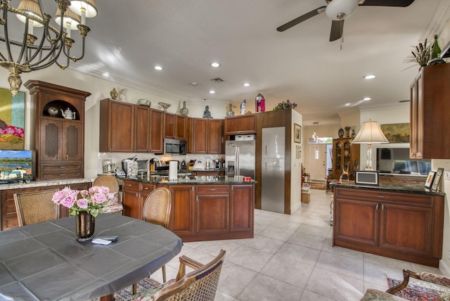 kitchen featuring kitchen peninsula, ceiling fan with notable chandelier, stainless steel appliances, and crown molding