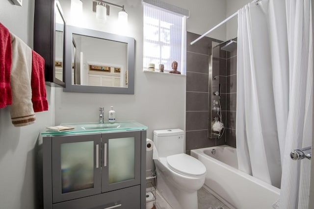 full bathroom with shower / tub combo with curtain, vanity, and toilet