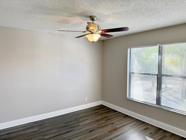 unfurnished room featuring ceiling fan, dark wood-type flooring, and a textured ceiling