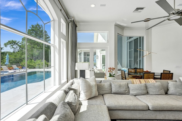 sunroom / solarium with french doors and ceiling fan