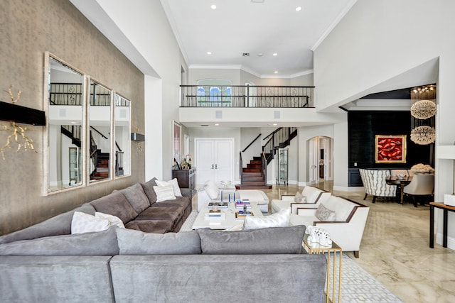 living room featuring crown molding and a high ceiling