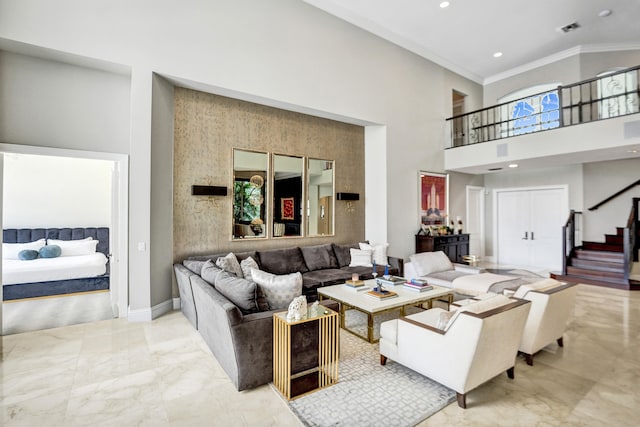 living room featuring crown molding and a towering ceiling