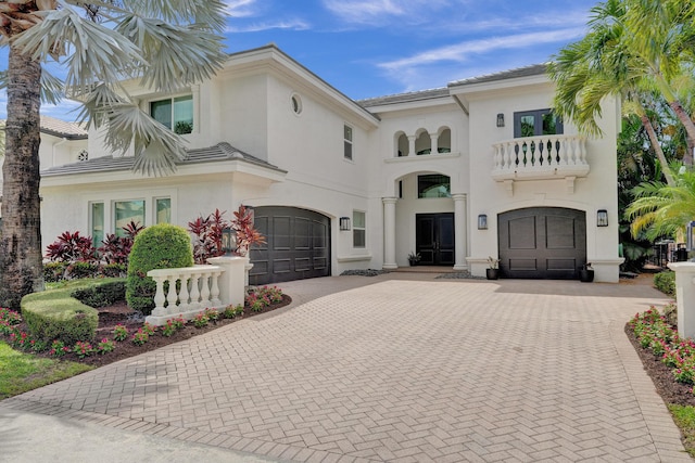 mediterranean / spanish-style home with a balcony and a garage