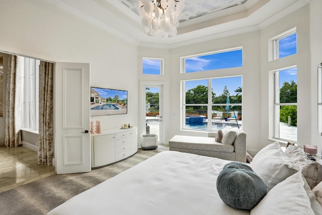 bedroom featuring light carpet, ornamental molding, a high ceiling, and a notable chandelier