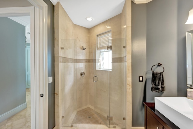 bathroom with crown molding, vanity, and a shower with shower door