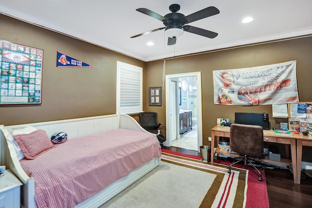 bedroom featuring hardwood / wood-style floors, connected bathroom, ceiling fan, and ornamental molding