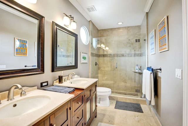 bathroom with crown molding, vanity, a shower with shower door, and toilet