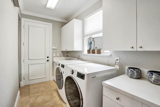 laundry room featuring cabinets, washer and dryer, and ornamental molding