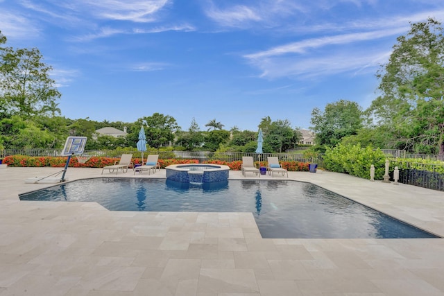 view of swimming pool featuring an in ground hot tub and a patio