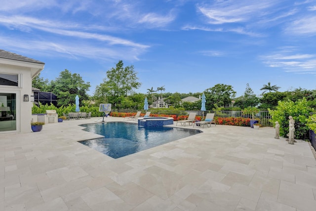 view of swimming pool with a patio area and an in ground hot tub