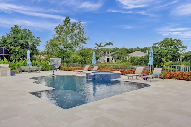 view of swimming pool with area for grilling, an in ground hot tub, and a patio