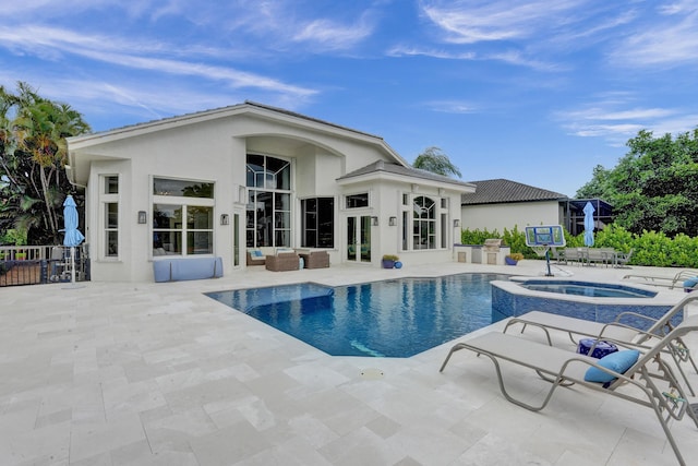 view of pool featuring an in ground hot tub and a patio