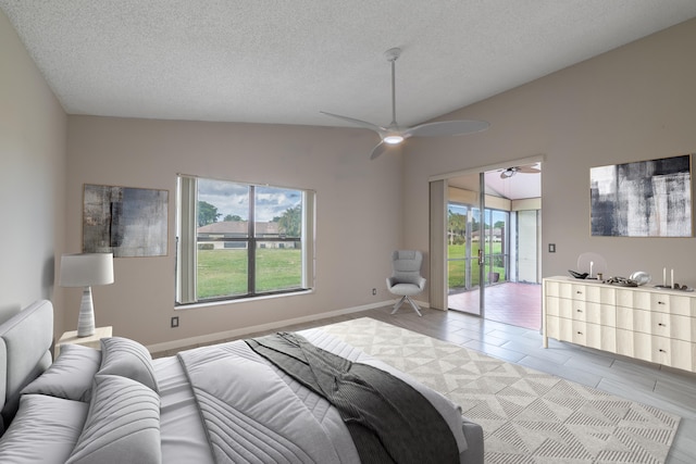 bedroom with access to exterior, a textured ceiling, multiple windows, and ceiling fan