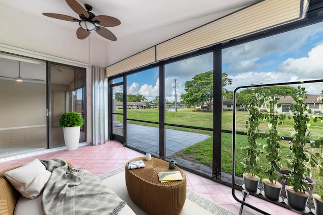 sunroom featuring ceiling fan