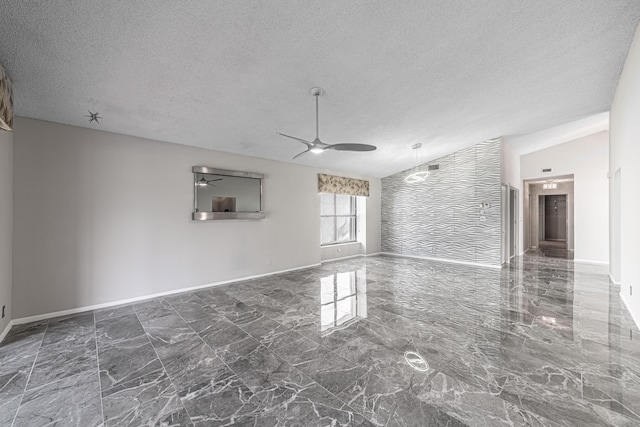 unfurnished living room with a textured ceiling, vaulted ceiling, and ceiling fan