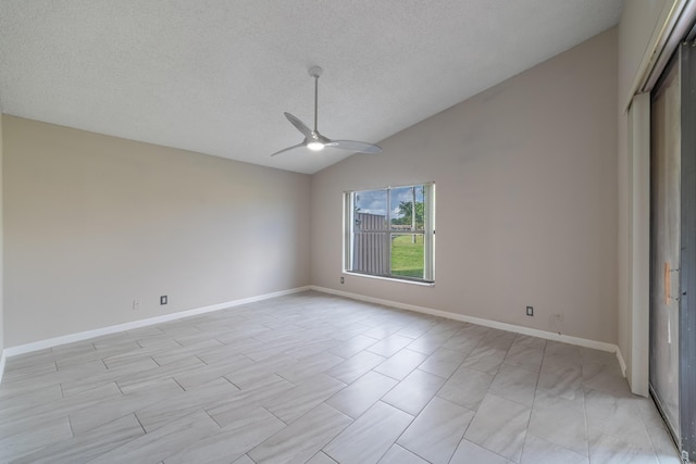 interior space featuring ceiling fan, lofted ceiling, a textured ceiling, and a closet