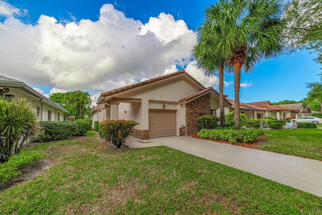 view of front of home with a front yard and a garage